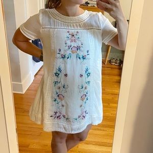 White dress with floral appliqué